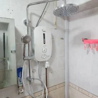 a shower with a shower head and Rainshower Set After installation