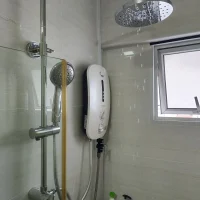 a Rainshower with a shower head and a white instant Heater